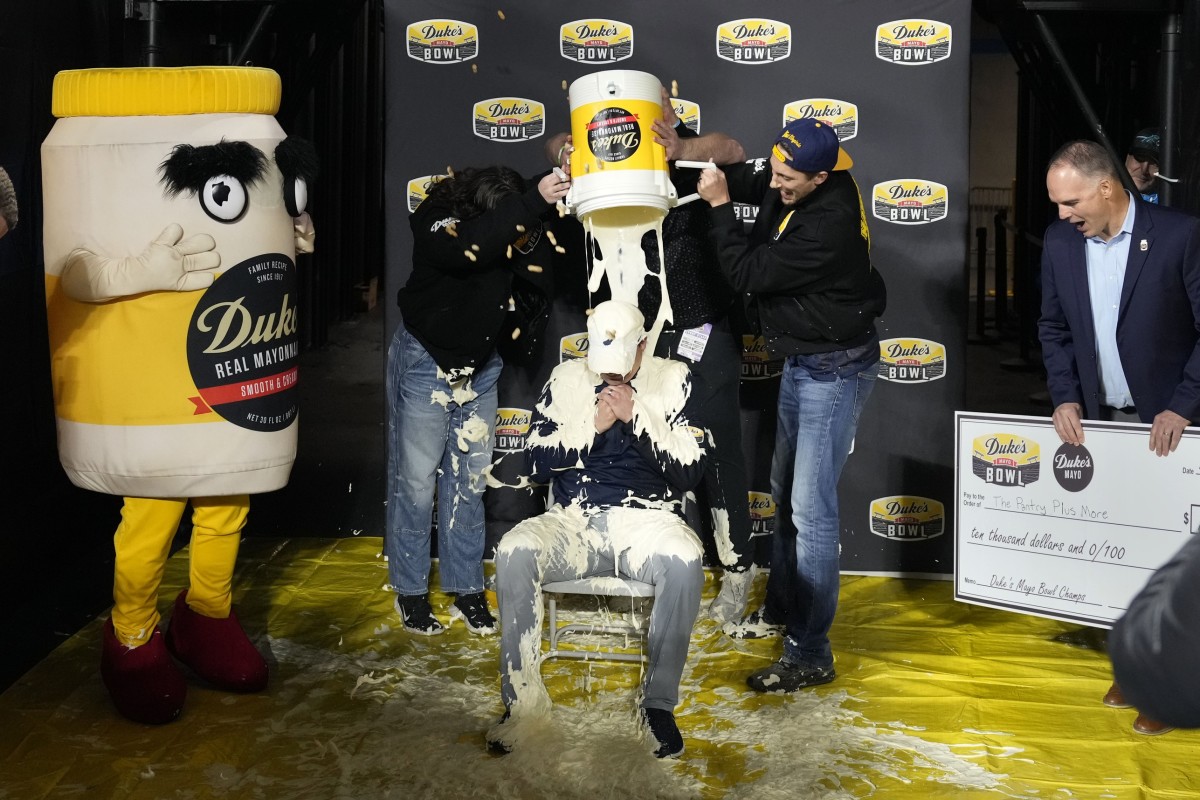 WVU head coach Neal Brown receiving the mayo bath after beating North Carolina in the Duke's Mayo Bowl - Bob Donnan (USA TODAY Sports)